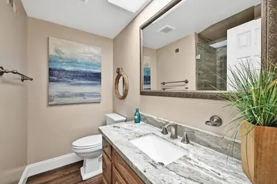 a bathroom with a sink and a toilet at Giant Beachfront Home with Parking near the Pier in Newport Beach