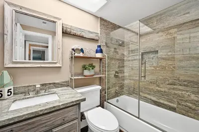 a bathroom with a toilet and a sink and a shower at Giant Beachfront Home with Parking near the Pier in Newport Beach