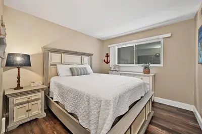 a bedroom with a bed and a window at Giant Beachfront Home with Parking near the Pier in Newport Beach