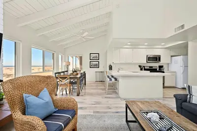 a living room with a couch and a table at Beachfront home with Sweeping Ocean Views, AC, Walk to the Pier, Restaurants, Shops, Activities in Newport Beach