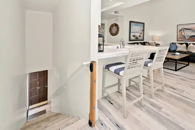 a living room with a white desk and chairs at Beachfront home with Sweeping Ocean Views, AC, Walk to the Pier, Restaurants, Shops, Activities in Newport Beach