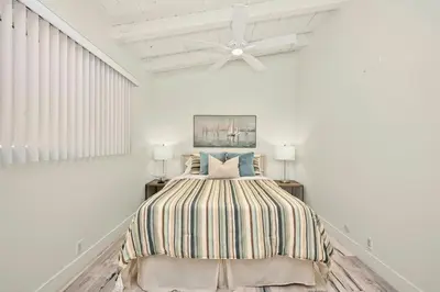 a bedroom with a bed and a ceiling fan at Beachfront home with Sweeping Ocean Views, AC, Walk to the Pier, Restaurants, Shops, Activities in Newport Beach