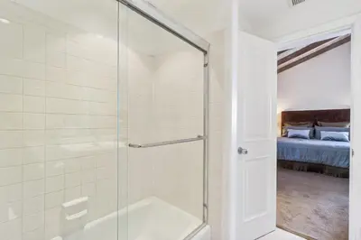 a bathroom with a shower with a glass door at 2 Homes Rented Together on the Oceanfront in Newport Beach