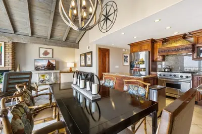 a dining room and kitchen with a table and chairs at 2 Homes Rented Together on the Oceanfront in Newport Beach