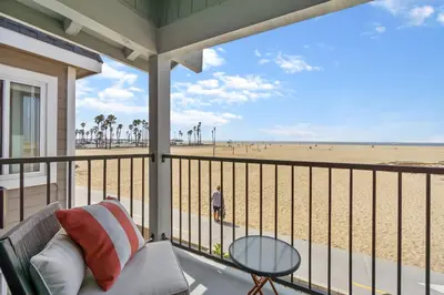 a screened porch with a view of the beach at 2 Homes Rented Together on the Oceanfront in Newport Beach