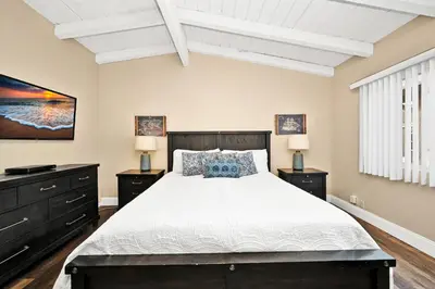 a bedroom with a large bed and two night stands at Stunning Oceanfront Retreat in Newport Beach in Newport Beach
