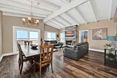a dining room and living room with a table and chairs at Stunning Oceanfront Retreat in Newport Beach in Newport Beach