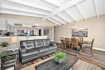 a living room with a couch and a dining room at Stunning Oceanfront Retreat in Newport Beach in Newport Beach