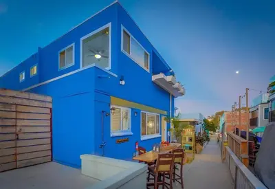 a blue building with a table on a street at Ocean View Blue Mission Beach Paradise in San Diego