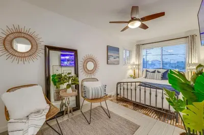 a bedroom with a bed and a ceiling fan at Ocean View Blue Mission Beach Paradise in San Diego