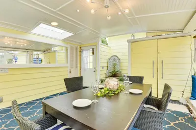a dining room with a wooden table and chairs at Carlsbad Bungalow Patio, Hot Tub, Close to Beach! in Carlsbad