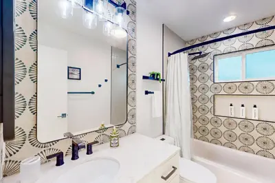a bathroom with a sink and a mirror at Dog-Friendly Home Saltwater Pool, Fire Pit, Games in San Diego