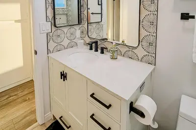 a bathroom with a sink and a mirror at Dog-Friendly Home Saltwater Pool, Fire Pit, Games in San Diego