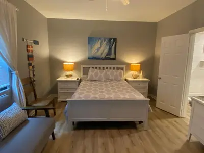 a bedroom with a bed and two lamps and a couch at Newport Beach House in Newport Beach