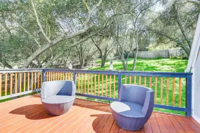 two chairs sitting on a deck with a fence at North San Diego Retreat with Deck, Fire Pit Table! in Escondido