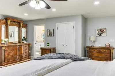 a bedroom with a bed and a ceiling fan at North San Diego Retreat with Deck, Fire Pit Table! in Escondido