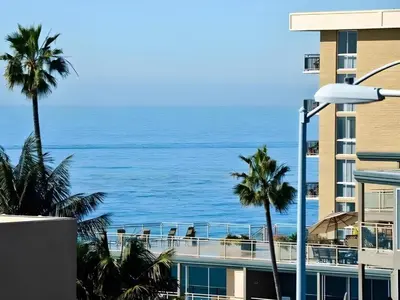 a view of the ocean from the balcony of a hotel at Laguna Brisas - A Beach Hotel in Laguna Beach