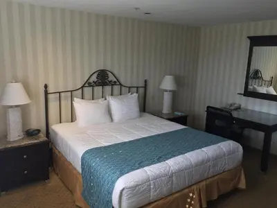 a hotel room with a bed and a desk at Laguna Brisas - A Beach Hotel in Laguna Beach