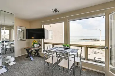 a dining room with a table and a view of the ocean at Ocean-View Imperial Beach Condo with Community Perks in Imperial Beach