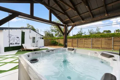 a hot tub in the backyard of a house at San Diego Chill House with Jacuzzi-Golf-Game Room in San Diego