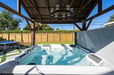 a jacuzzi tub in the middle of a patio at San Diego Chill House with Jacuzzi-Golf-Game Room in San Diego
