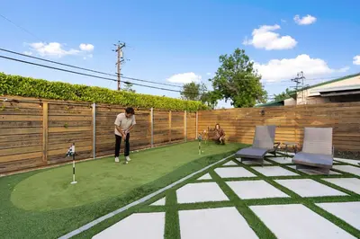 a person playing golf on a putting green at San Diego Chill House with Jacuzzi-Golf-Game Room in San Diego