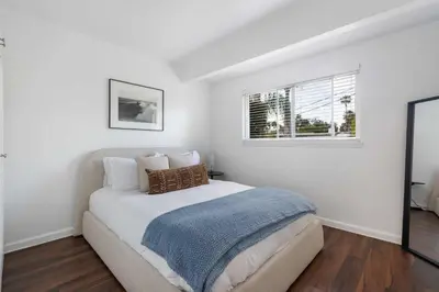 a white bedroom with a bed and a window at San Diego Chill House with Jacuzzi-Golf-Game Room in San Diego