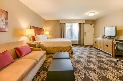 a hotel room with a bed and a couch at Hotel San Diego-Rancho Bernardo in Rancho Bernardo