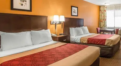 a hotel room with two beds and a desk at El Cajon San Diego East in El Cajon