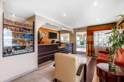 a living room with a bar and a table at El Cajon San Diego East in El Cajon