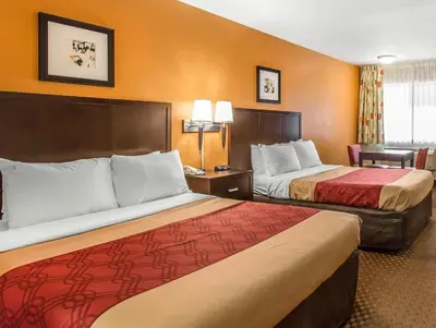 a hotel room with two beds and a desk at El Cajon San Diego East in El Cajon