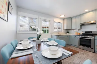 a kitchen and dining room with a table and chairs at Pet Friendly Beach Bungalow, Close to Beach in Carlsbad