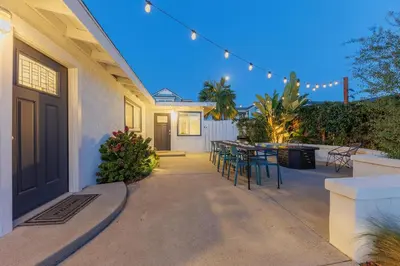 a patio with a table and chairs on a house at Walk to Beach, Outdoor Living, Pet-Friendly! in Carlsbad