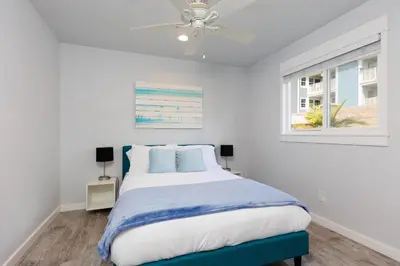 a bedroom with a bed and a ceiling fan at Walk to Beach, Outdoor Living, Pet-Friendly! in Carlsbad