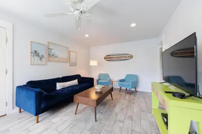 a living room with a blue couch and two blue chairs at Walk to Beach, Outdoor Living, Pet-Friendly! in Carlsbad