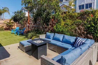 a patio with a blue couch and a table at Walk to Beach, Outdoor Living, Pet-Friendly! in Carlsbad