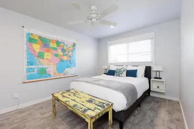 a bedroom with a bed and a map on the wall at Walk to Beach, Outdoor Living, Pet-Friendly! in Carlsbad