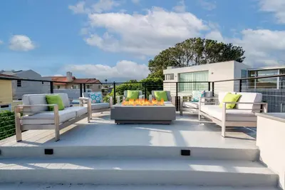 a patio with chairs and a fire pit on a balcony at CBS-1236 - Sensational Summit Sunsets in Cardiff-by-the-Sea
