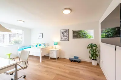 a white bedroom with a bed and a desk at CBS-1236 - Sensational Summit Sunsets in Cardiff-by-the-Sea