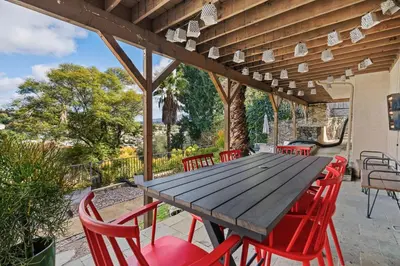 a wooden table and red chairs on a patio at Executive Retreat - Renovated - Spacious - Views in La Mesa