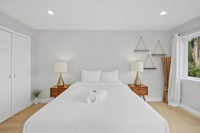 a white bedroom with a large white bed and a window at Executive Retreat - Renovated - Spacious - Views in La Mesa