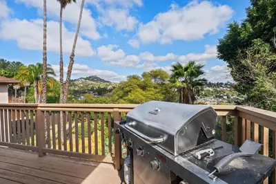 a grill on a deck with palm trees at Executive Retreat - Renovated - Spacious - Views in La Mesa