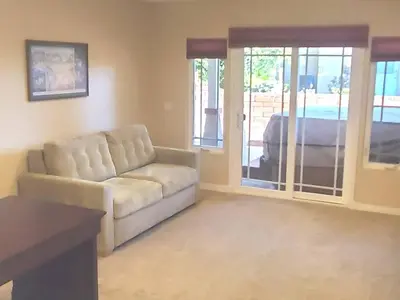 a living room with a couch and a sliding glass door at Villa Solamar-Sunset Cliffs Spectacular in San Diego