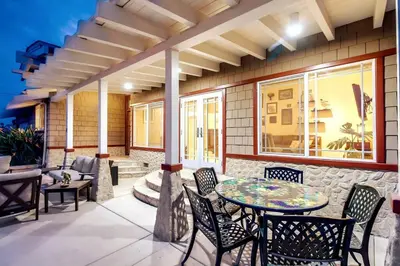 a patio with a table and chairs on a building at Villa Solamar-Sunset Cliffs Spectacular in San Diego
