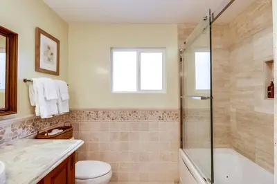 a bathroom with a shower and a toilet and a sink at Villa Solamar-Sunset Cliffs Spectacular in San Diego