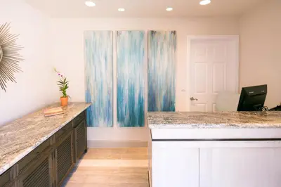 a kitchen with a counter top and a table at La Jolla Riviera Inn in San Diego