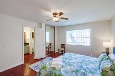 a bedroom with a bed and a ceiling fan at Steps to Restaurants Beach Bay Park Bars in San Diego