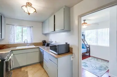 a kitchen with a sink and a microwave at Steps to Restaurants Beach Bay Park Bars in San Diego