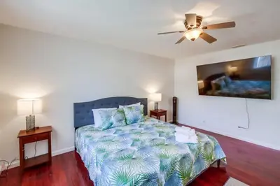 a bedroom with a bed and a ceiling fan at Steps to Restaurants Beach Bay Park Bars in San Diego