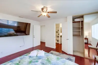 a living room with a bed and a ceiling fan at Steps to Restaurants Beach Bay Park Bars in San Diego